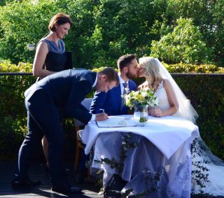 Signing the Register with wedding celebrant