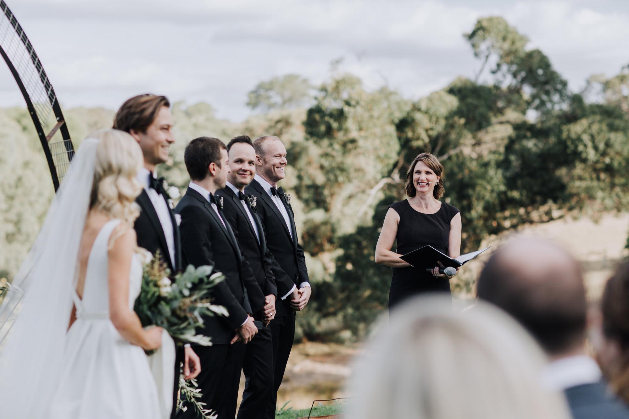 Celebrant stands to side of wedding party so that bride and groom are the centre of attention. 