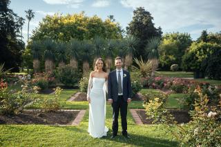 bride and groom standing side by side and holding hands in st kilda gardens