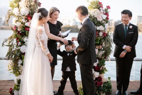 Celebrat Meriki Comito assisting young ring bearer during marriage ceremony