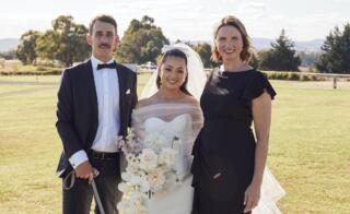 Bride + Groom posing for photo with female marriage celebrant and dog