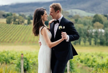 Bride + Groom in a dance embrace during wedding ceremony at vineyard