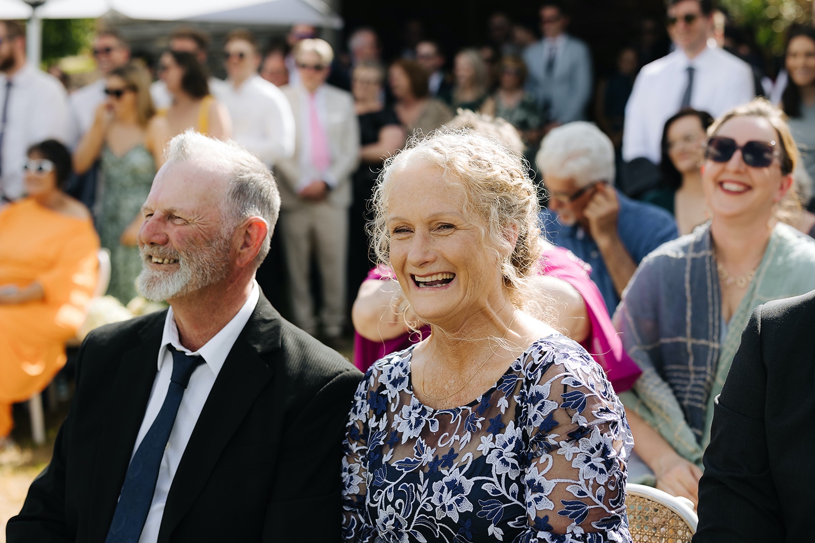 Wedding planning with Intention Guests laughing and enjoying themselves during an outdoor wedding ceremony
